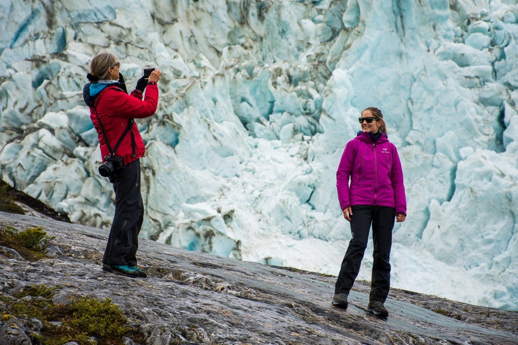 Traveler standing near a glacier during an expedition landing in southern Patagonia.